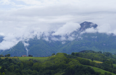 Over the green mountain, the old farmhouse looked imposingly at the Txindoki, whose peak was sometimes hidden behind the clouds.