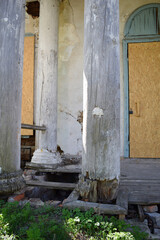 Wooden columns of an ancient 18th century building damaged by time.