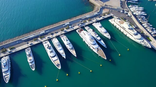 Aerial view of Super Mega Yachts in the French Riviera in the port of Antibes - Aerial sunrise flyover	