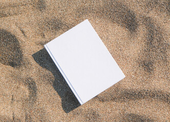 blank book mockup on sandy beach
