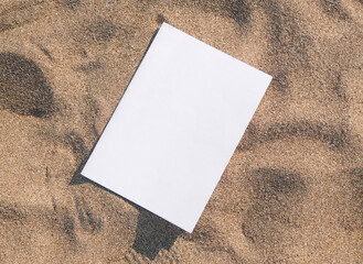 blank magazine mockup on sandy beach