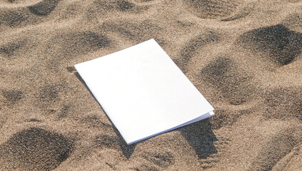 blank magazine mockup on sandy beach