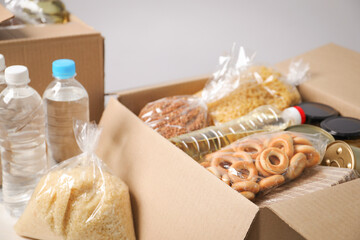 Different food products in boxes on light table, closeup