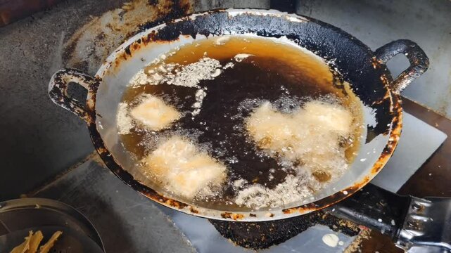 fry some slices of breadfruit in a pan filled with boiling oil