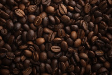 Fototapeta premium Roasted coffee beans filling the frame, rich brown tones.