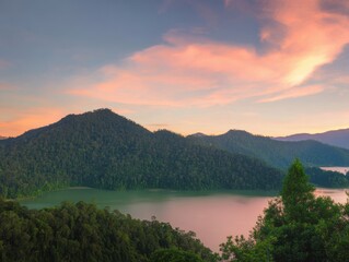 Serene Landscape of Lush Green Mountains Overlooking a Tranquil Lake Under a Colorful Sunset Sky