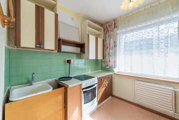 Fototapeta premium Vintage Kitchen with Old Cabinets and Bright Window Lighting