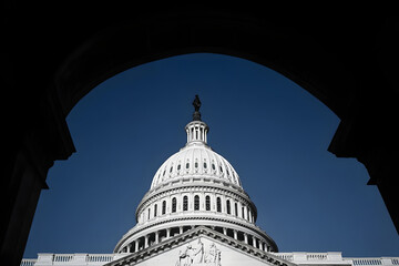 The United States Capitol dome against a clearing blue sky viewed from the east front of the U.S. Capitol building in Washington, DC.