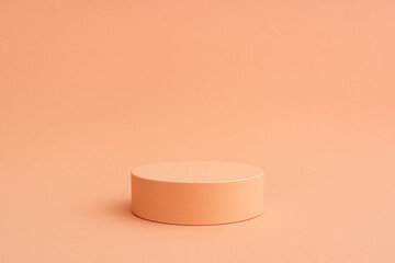 A minimalist round pedestal displayed against a soft peach background. This simple yet elegant setup is perfect for product showcases, branding, or artistic presentations.