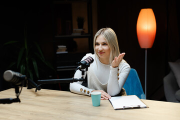 Smiling woman recording podcast in home studio