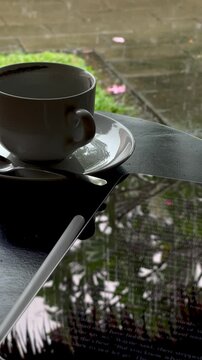 Rainy Afternoon Coffee and Ebook at a Tropical Caf&eacute; Table