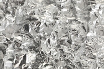Crumpled shiny aluminum foil as background, closeup