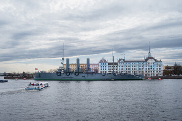 Saint Petersburg, Russia - 02.05.25. Cruiser Aurora and Naval Academy by the River Neva in St....