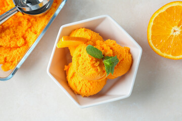 Tasty orange sorbet, fresh fruit, mint and scoop on light table, flat lay