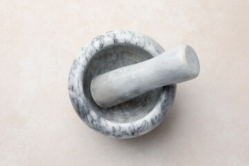 Marble mortar and pestle on white table, top view