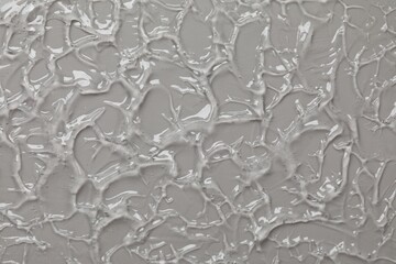 Collagen gel on grey background, top view