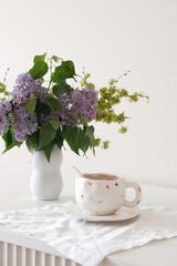 A lovely tea setup with lilac flowers, perfect for relaxation and enjoying serene moments of tranquility