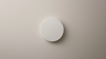 A white circle on a beige background.