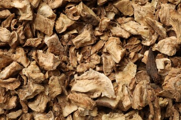 Pieces of dry chicory roots as background, closeup