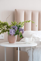 Create a Cozy and Inviting Bedroom Decor Featuring Beautiful Flowers and a Warm Cup of Tea