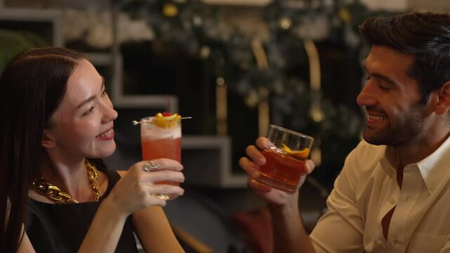 Smiling beautiful woman making a toast with Paloma cocktail to smart couple in Old fashioned savoring tasty enjoy drinking in lively conversation at bar refreshing special nightclub party. Vinosity.