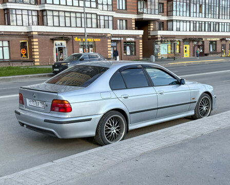 Silver car BMW E39 5-series 530d at the city street. BMW E39 5-series 530d parked on street. Exterior of a BMW E39 car. Germany classic car. 