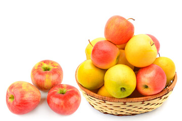Ripe juicy apples in a wicker basket isolated on white background.