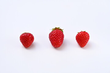 three fresh strawberries on white background isolate
