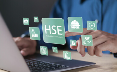 HSE, Health safety environment concept. Standard safe industrial work and industrial. Person using laptop with HSE icons on virtual screen for business and organization.