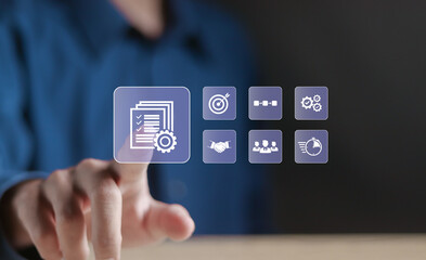 Project management concept. Planning, execution, monitoring, collaboration, resource allocation, risk management and reporting. Person touching project management icon on virtual screen.