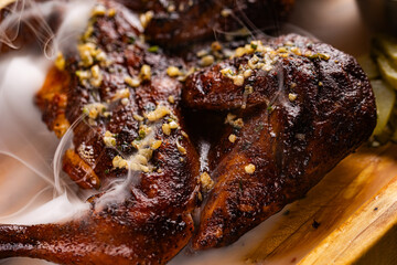 Closeup of roasted grilled whole chicken served at restaurant
