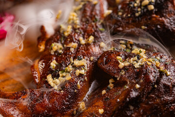Closeup of roasted grilled whole chicken served at restaurant