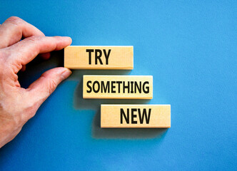 Try something new symbol. Concept words Try something new on beautiful block. Businessman's hand....