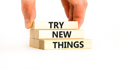 Try new things symbol. Concept words Try new things on beautiful wooden block. Businessman's hand. Beautiful white background. Business motivational lifestyle try new things concept. Copy space.