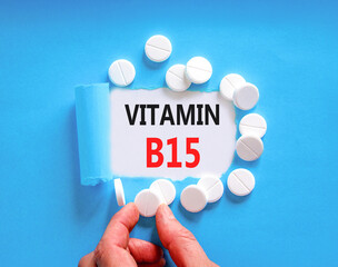 Vitamin B15 pantothenic acid symbol. Concept words Vitamin B15 on beautiful white paper. White pills tablets. Doctor's hand. Beautiful blue background. Medical healthy lifestyle Vitamin B15 concept.