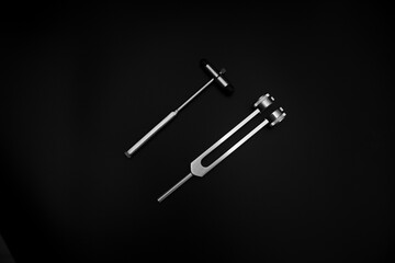 neurological hammer on a black background. medical instrument on a black background, medical equipment lies.