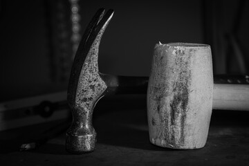 The hammer and mallet on the workbench in the basement of the house