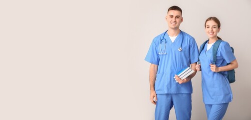 Portrait of medical students on light background with space for text