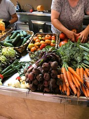 Fototapeta premium Selection of organic vegetables at a farmers market includes beetroots, carrots, tomatoes, lettuce and cucumbers. Basque Country. Market offering San Sebastian.