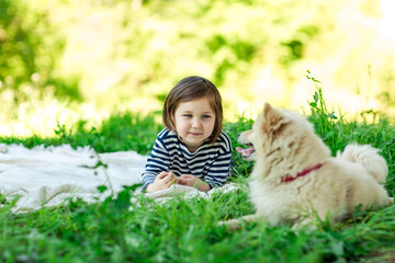Beautiful girl with a Pomeranian dog