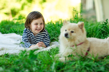 Beautiful girl with a Pomeranian dog