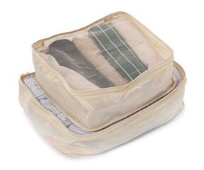 Beige packing cubes with folded clothes isolated on white