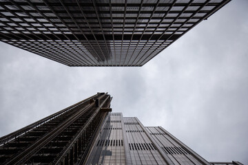 Symmetrical modern building, looking up sky, NYC