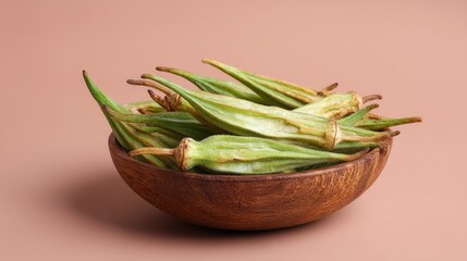 Okra Harvest Fresh Green Veggies in Wooden Bowl on Neutral Background.