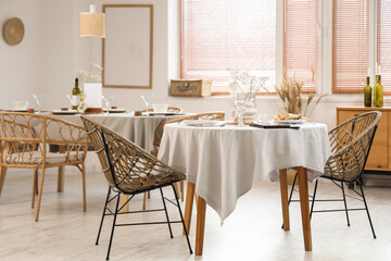 Interior of light restaurant with tables and window