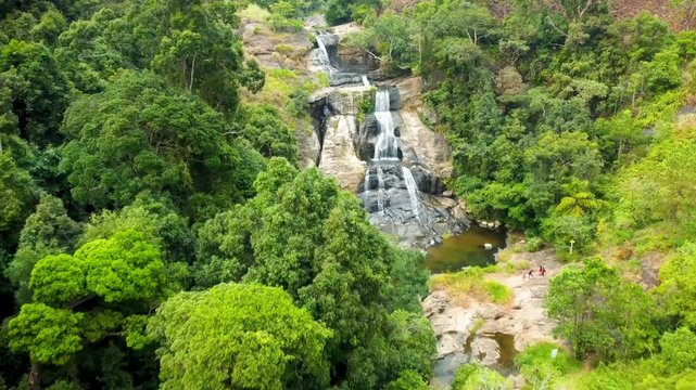 Spectacular drone footage of Diyaluma Waterfall, Sri Lanka's stunning natural wonder. Captured from top, the video showcases the powerful cascade surrounded by lush jungle. Perfect for nature 