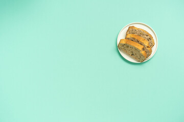 Nut cake alone on minimal pastel turquoise background.