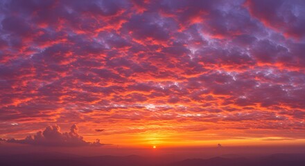 Fototapeta premium Fiery Sunset with Clouds Painting the Sky in Red and Purple