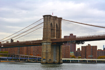 An ancient English bridge arches gracefully over calm waters, with historic stonework. In the...