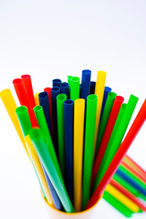 Vibrant reusable straws in cup isolated over clean white background